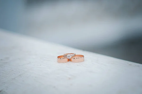 Pair of gold wedding rings on the white marble — Stock Photo, Image