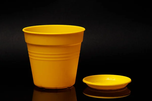 Yellow flower pot with stand on the black background — Stock Photo, Image