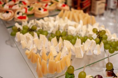 Düğün büfesi. Farklı peynir çeşitleri dilimleniyor