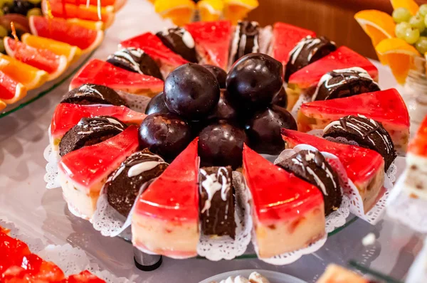 Sweet cakes at a wedding buffet. Catering