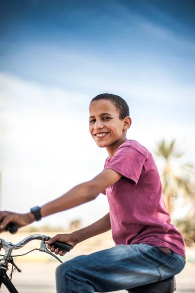 Boy on the bike in the town Zagora, Morocco