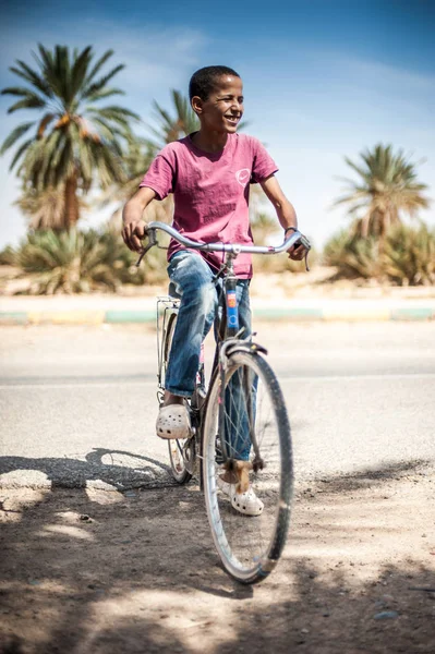 Boy on the bike in the town Zagora, Morocco