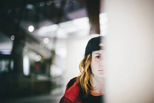 Kırmızı ceketli dalgın yüz Sanat Galerisi'nde duvarın yanında poz ile şık kap ayakta giyen trendy sevimli kız yarım yüz