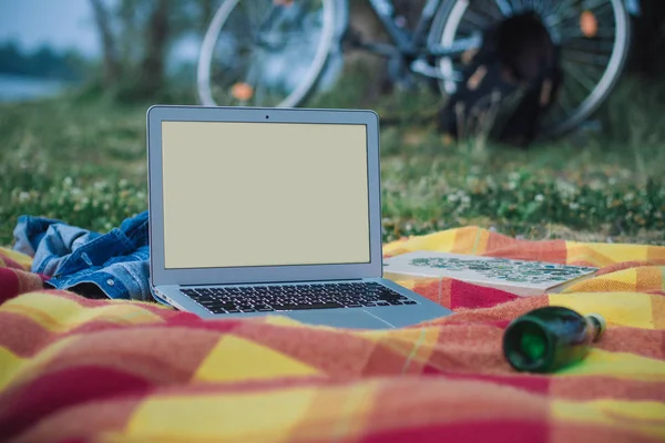 A laptop with solid screen outdoor with colorful background