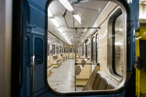 Kyiv metro wagon interior with no people through the window