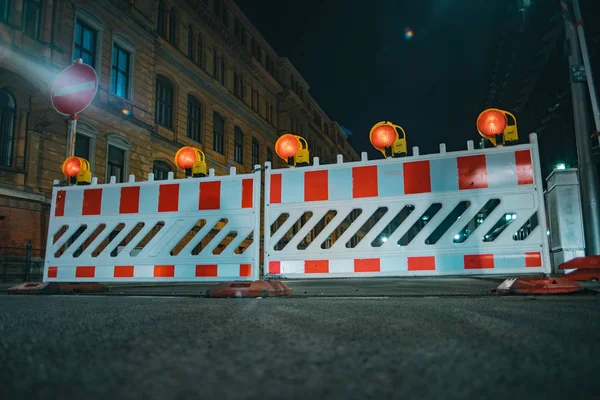 Road barriers with orange lamps as a fencing on road repair