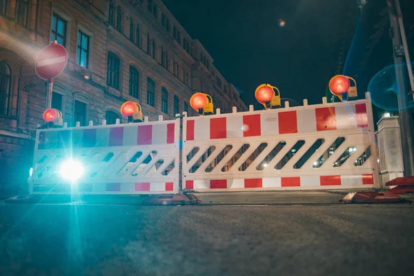 Road barriers with orange lamps as a fencing on road repair