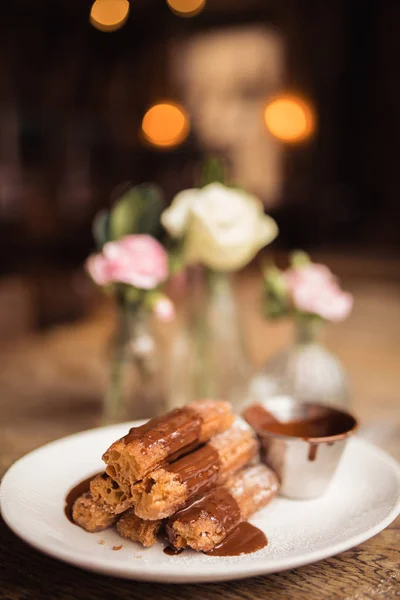 Tarçın şeker çikolata sosu ile churros tozlu. Gıda, tatlı ve pişirme kavramı. Geleneksel Meksika yemekleri.