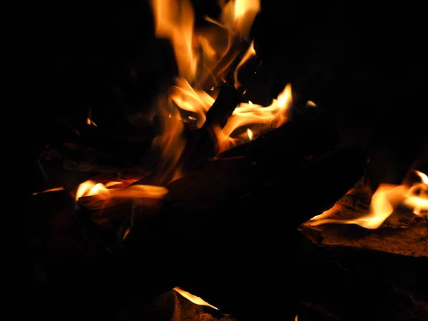 bonfire burning at camping at night, hiking and travel