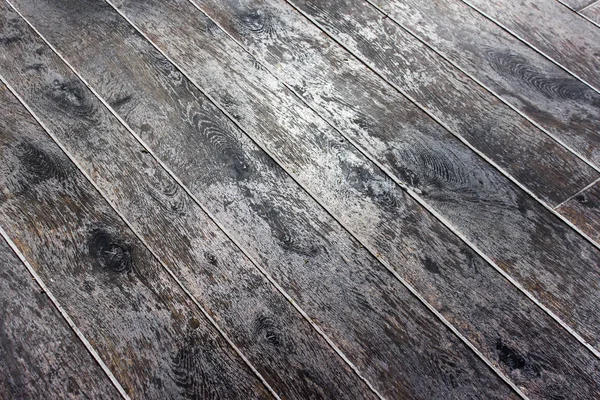 Weathered wooden flooring. Diagonal photo of shiny wooden floor.