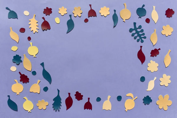 Abstract template with flowers, apples, leaves cut from fabric laying on the blue background. Photo with copy blank empty space on the right.