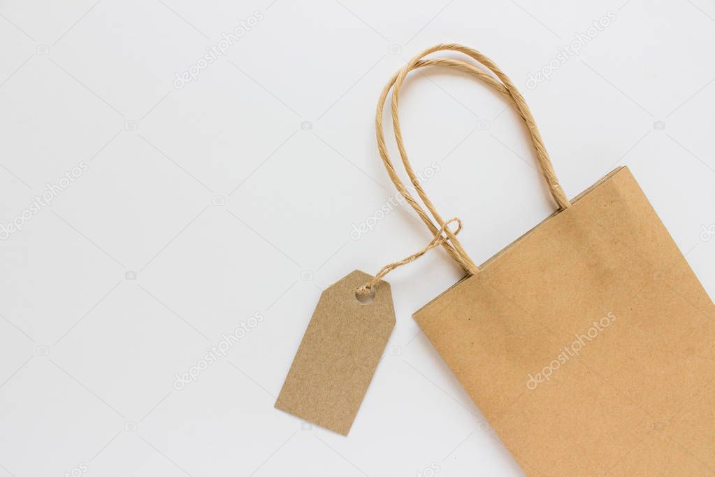 Blank mockup label tag kraft paper present shopping bag on white