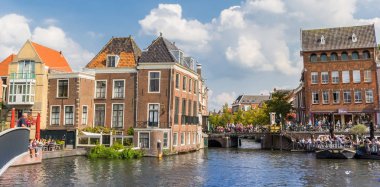 Panorama of old houses at the central canals of Leiden, Netherlands clipart