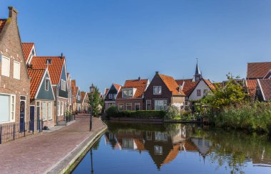 Street with small houses at the canal of Volendam, Holland clipart