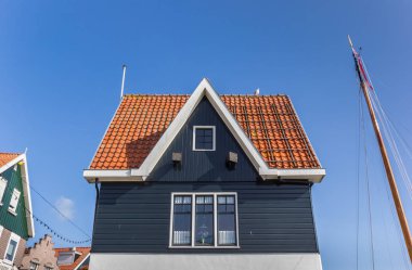 Facade of a historic house in the harbor of Volendam, Netherlands clipart