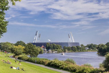Soccer stadium along the river Weser in Bremen, Germany clipart