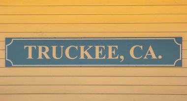 Wooden sign at the wall of the Truckee railway station in California, USA clipart