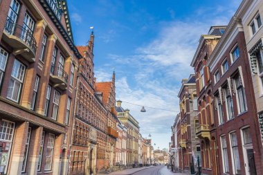 Street with old buildings in the historic city Groningen, Netherlands clipart
