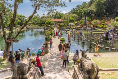Tourists on the central footpath of Taman Tirta Gangga water pal clipart