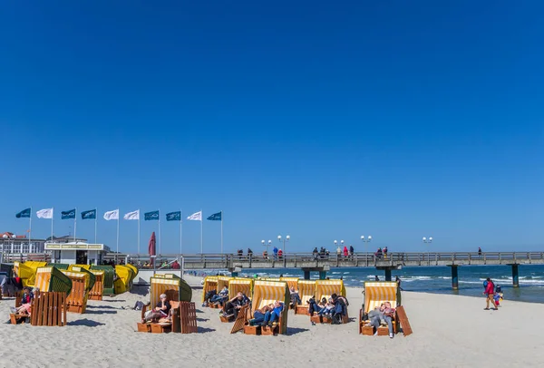 Les gens qui se détendent dans des chaises de plage traditionnelles à Binz — Photo