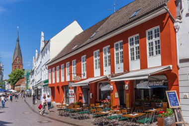 Colorful restaurant and church tower in Flensburg clipart