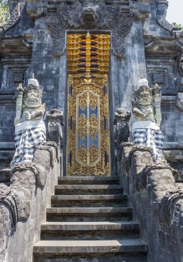 Door of the historic Pura Goa Lawah temple on Bali clipart