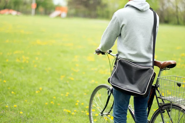 公園で自転車を持っている若い女性は ロイヤリティフリーのストック写真