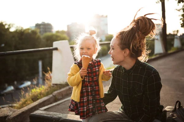 mom with dreadlocks and toddler eating ice cream