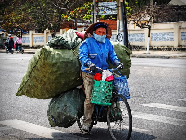 Kadın-wastepicker çekilen çöp ile bisiklet sürmek