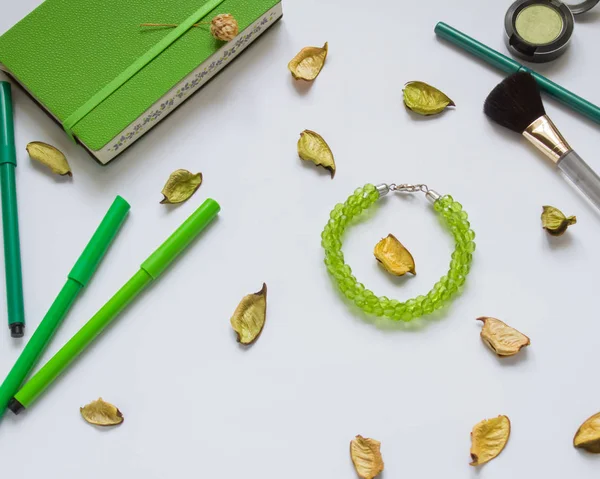 stock image green Notepad and pencils on white background, cosmetics, brush, jewelry, female