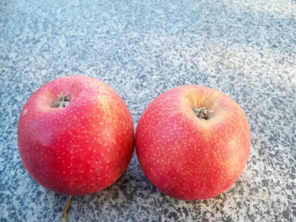 close view red sweet apples on grey stone fence