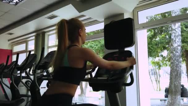Attractive Girl Running Exercise Bike Sport Gym Shot — Stock Video