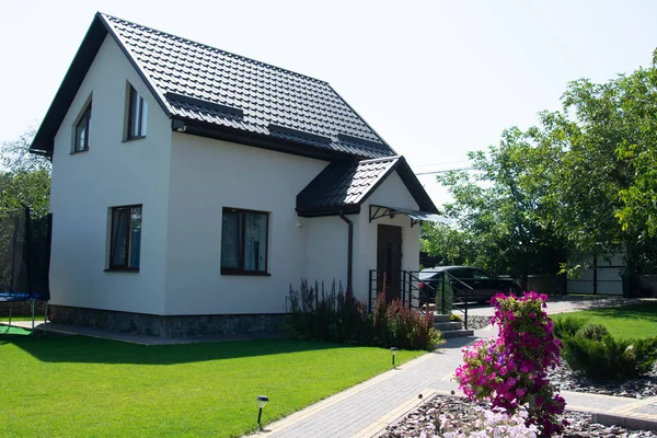 Yeşil çimenli, dış görünüşlü modern bir ev.