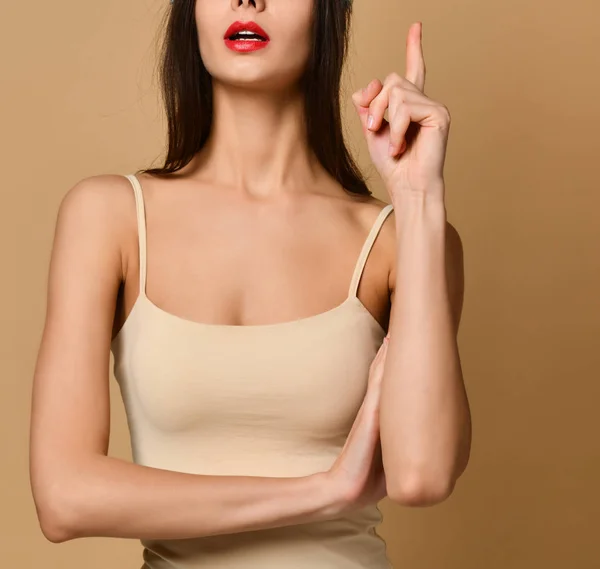 Retrato recortado de mujer emocional con el dedo índice levantado sobre fondo desnudo —  Fotos de Stock
