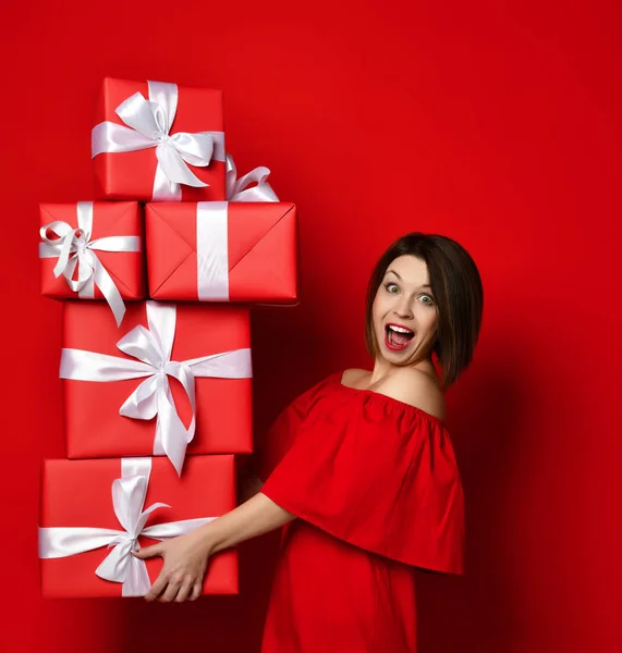 Vrouw in rode jurk met veel dozen — Stockfoto