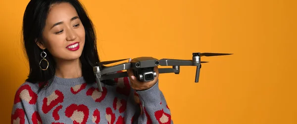 Joven linda chica sosteniendo quadcopter. Un niño jugando con un dron. Educación, niños, tecnología, ciencia, futuro y concepto de personas —  Fotos de Stock