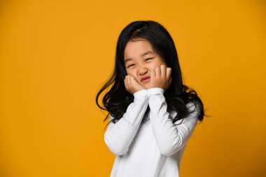 üzgün küçük Asyalı kız kafasını kaldırmış ve üzgün görünüyor..