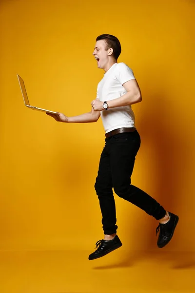 Estudiante saltando con portátil — Foto de Stock