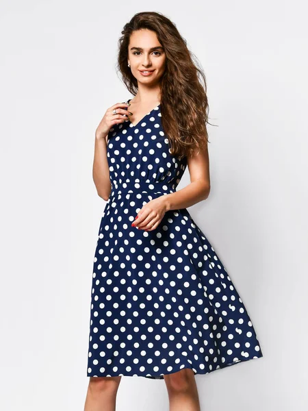 Woman in polka dot Dress in Fashion Store - Portrait of girl in a clothes shop in a midi summer dress