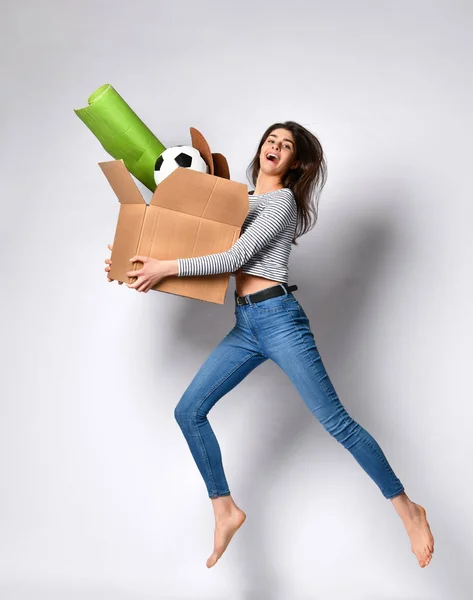 Young woman holding box with things.