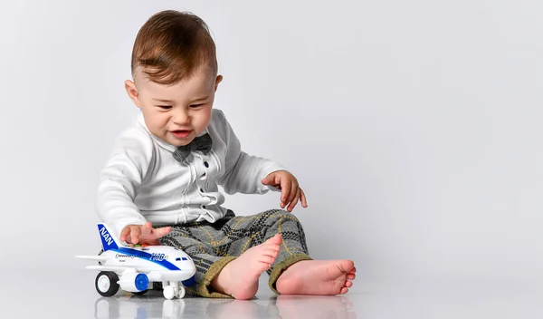 Happy child toddler playing with toy airplane and dreaming of becoming a pilot — Stock Photo, Image