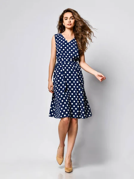 Woman in polka dot Dress in Fashion Store - Portrait of girl in a clothes shop in a midi summer dress