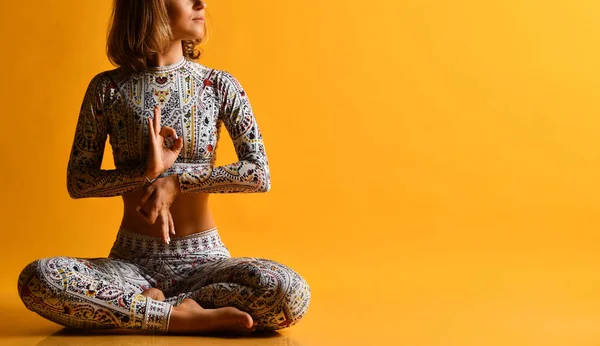 Ung attraktiv kvinna tränar yoga, tränar, bär sportkläder, full längd på en gul bakgrund i studion. Isolerade — Stockfoto