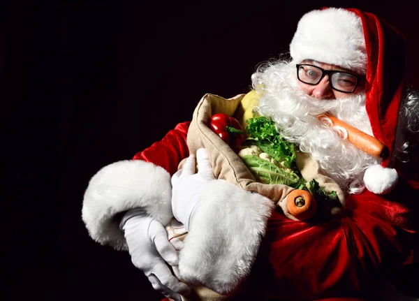 Santa Claus with a bag full of vegetables and fruits — Stock Image Santa Claus with a bag full of vegetables and fruits Royalty Free Stock Photos
