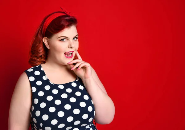 Kızların bağcıklarını bağla. Güzel bir kadın eski moda elbise ve benekli elbise içinde resim yapıyor. Stüdyo çekimi.