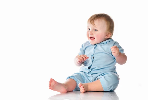 Little boy in a pajama bodysuit is playing in the studio on a white background. — Stock Photo, Image