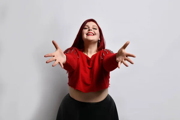 Come to me, let me hug you. Studio shot of thrilled overwhelmed redhead female pulling hands towards camera with affection in eyes, feeling desire to cuddle and express passionate emotions