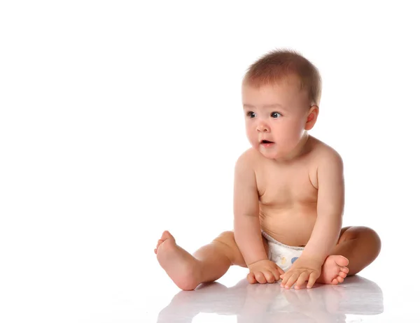 Little baby in nappy on floor stretching out by hand — Stock Photo, Image