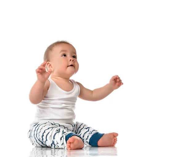 Cute plump baby boy in looking up sitting on floor — Stock Photo, Image