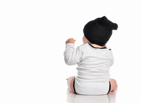 Enfant bébé tout-petit assis face à l'arrière à partir du dos isolé sur un fond blanc. — Photo